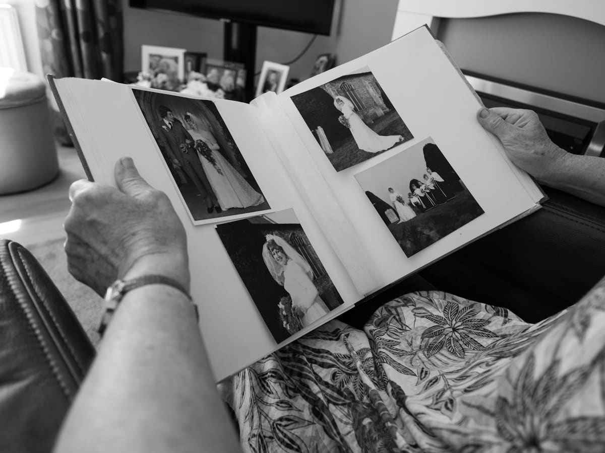 Person looking through black and white wedding album