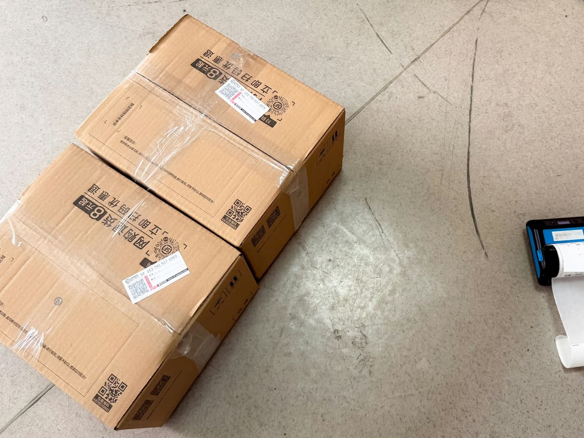 Brown shipping boxes next to a small label printer